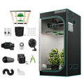 Black indoor grow tent with reflective interior, leafy plant, LED light, ventilation fan, pots, timer, and accessories