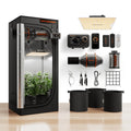 Indoor grow tent with plants, LED panel, ventilation fan, controller, carbon filter, fabric pots, and hanging accessories